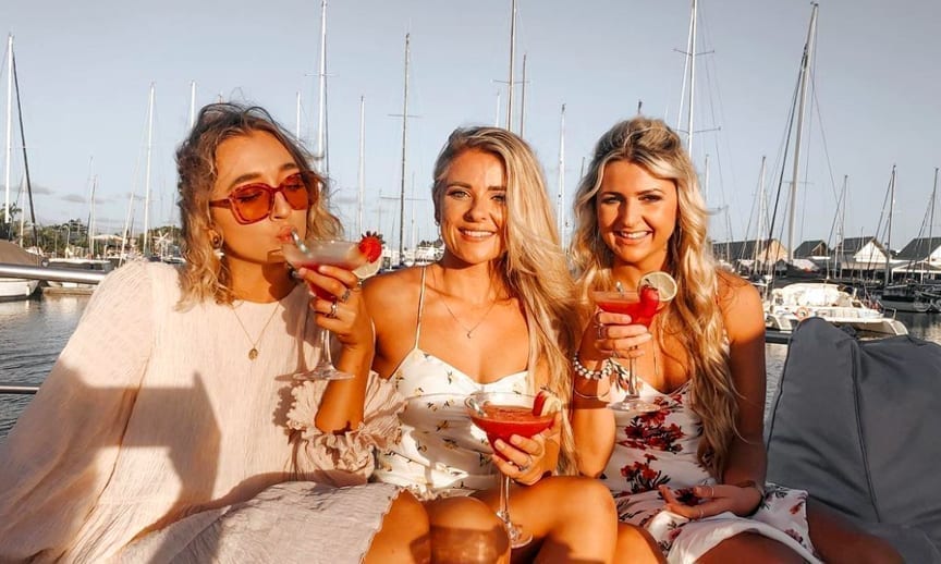 Young ladies enjoying a cocktail on the Bow of Crusader 1 during their cruise
